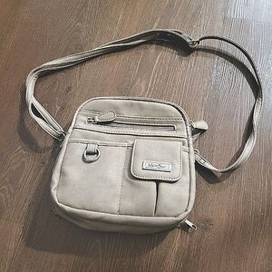 Multi Sak purse with several sections and pockets about 9" x 9"